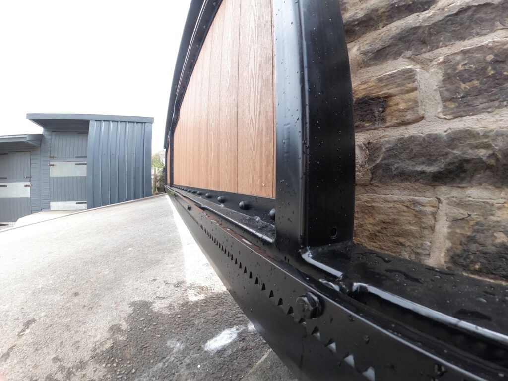 Automated Composite Cantilever Gate with Light Oak Inserts. Also features Keypad Access.